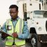 Industrial, outdoor and black man with clipboard in shipping for inspection, inventory check or del.